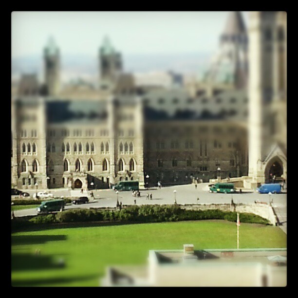 Green buses line up on Parliament Hill to shuttle MPs a few meters on a beautiful day.